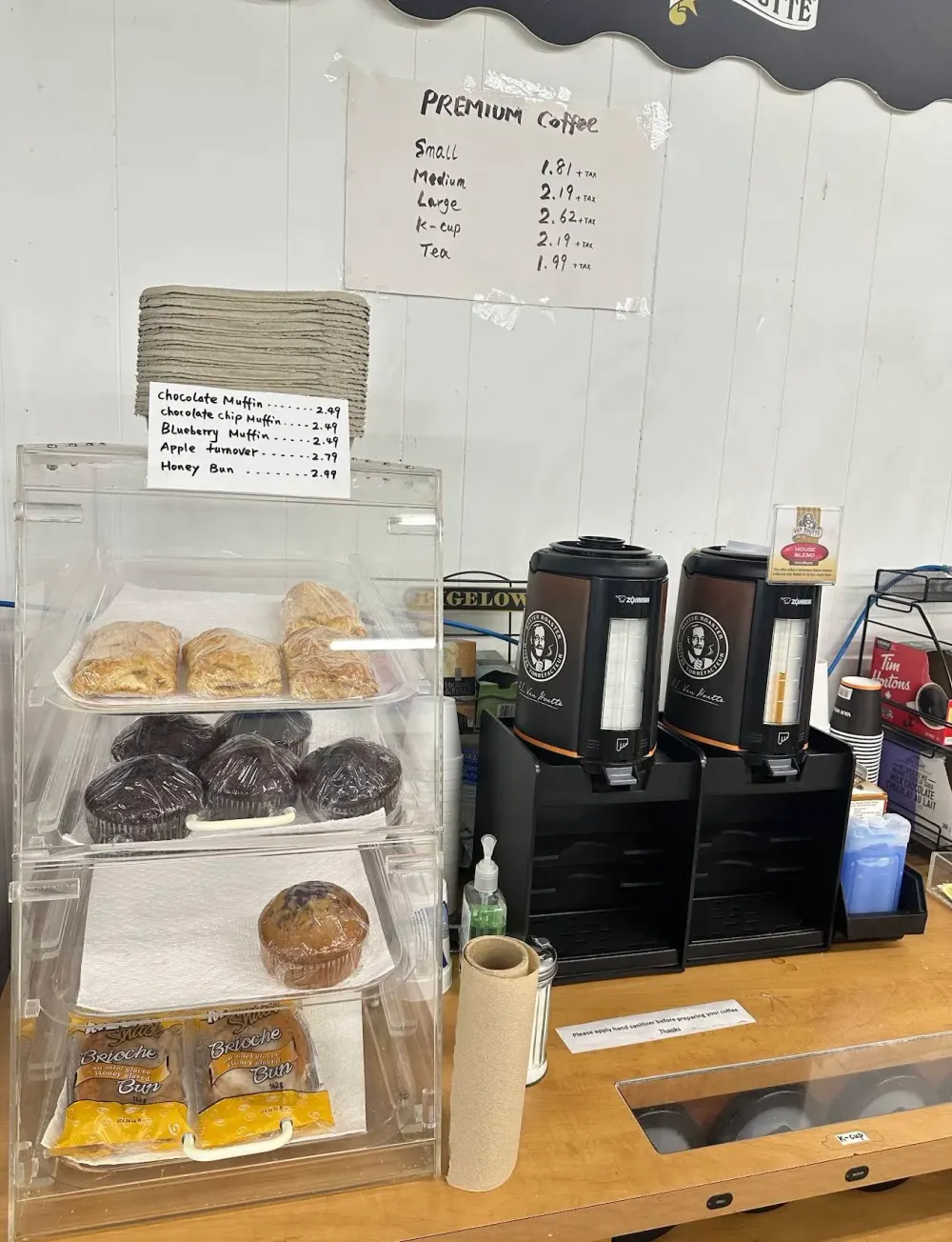 Coffee station with packaged muffins and pastries at Cheney Mini Mart