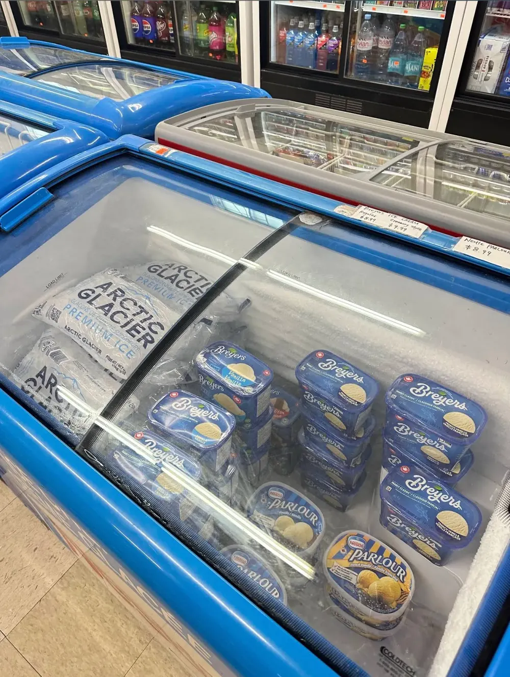 Freezer stocked with ice cream tubs and frozen desserts