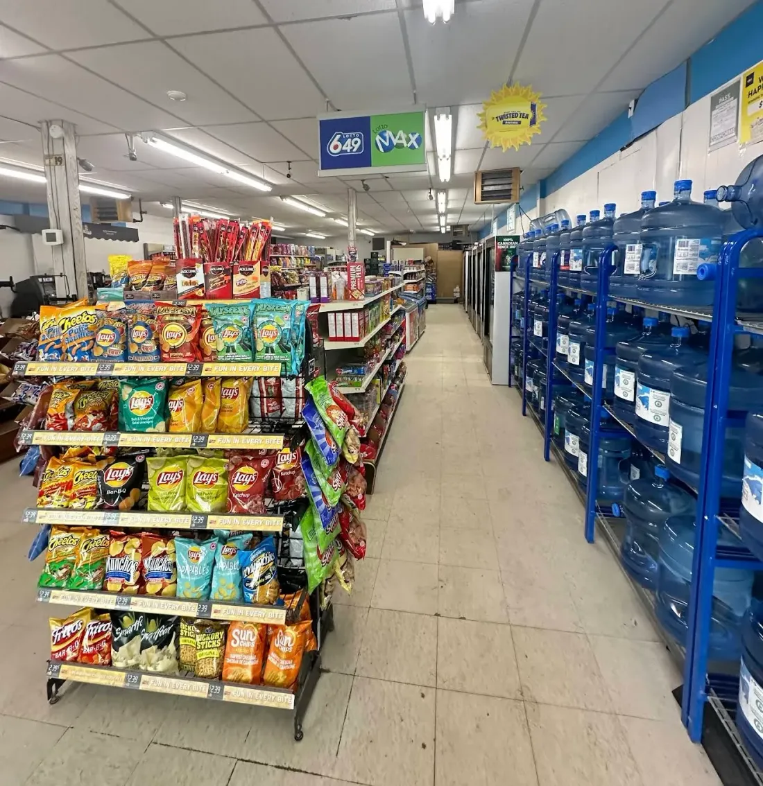 Store aisle with large water jugs and everyday products